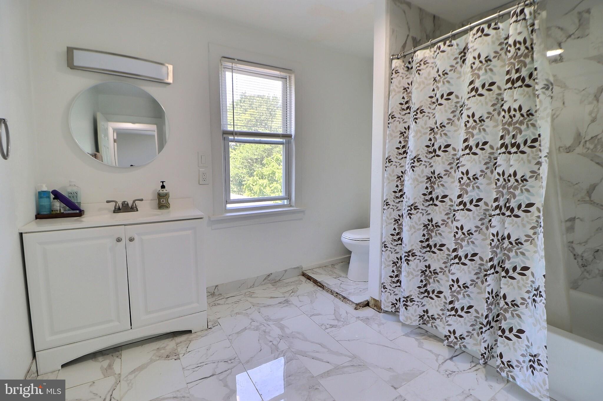 1022 Penn Line Road Paulsboro, NJ 08066 - Photo 14 of 19 a bathroom with a sink toilet and shower