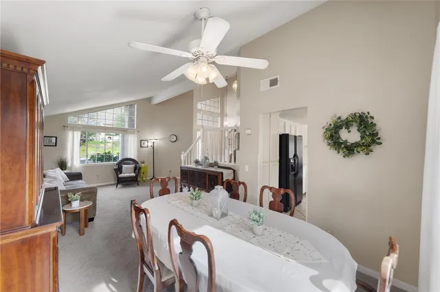 a living room with furniture a chandelier and a dining room