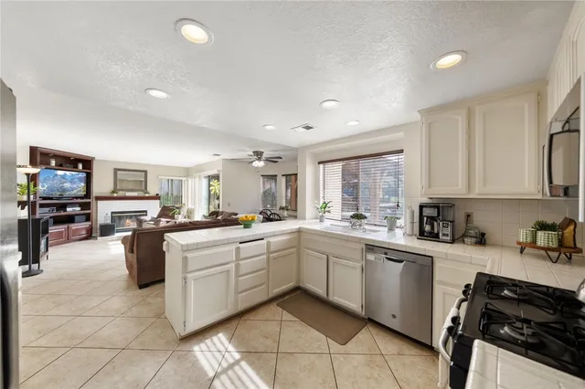 a kitchen with a sink counter top space appliances and cabinets