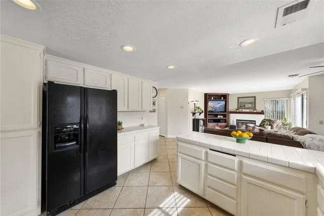 a kitchen with a refrigerator and microwave