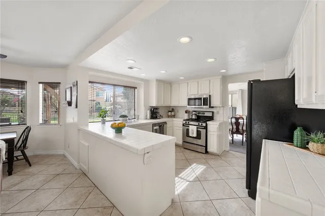 a kitchen with refrigerator and cabinets