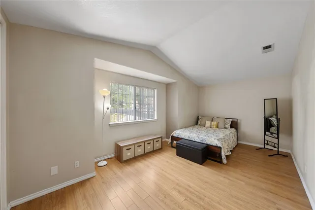 a bedroom with a bed and a window