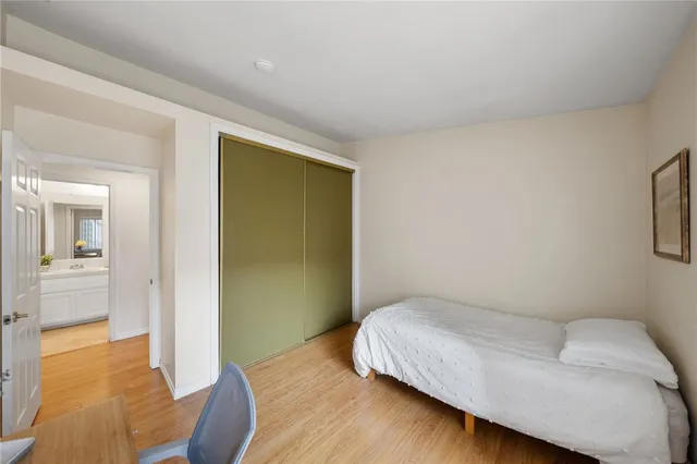 a bedroom with a bed and a chair in it