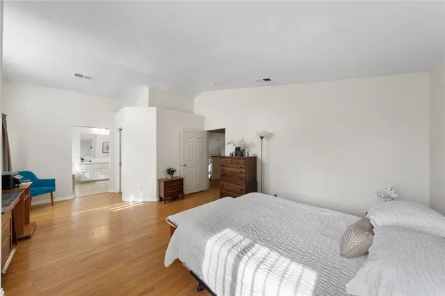 a bedroom with a bed and a large window