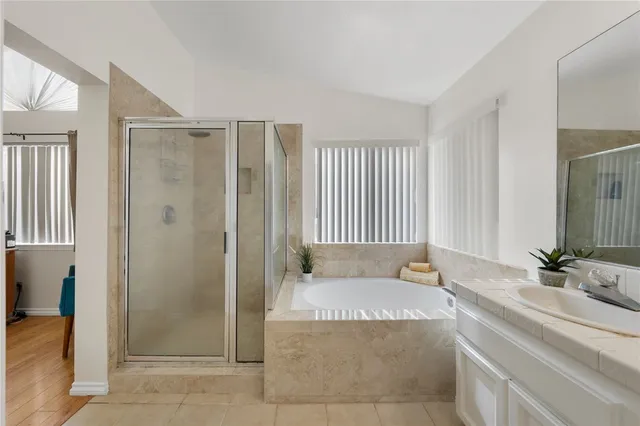 a spacious bathroom with a bathtub shower and sink