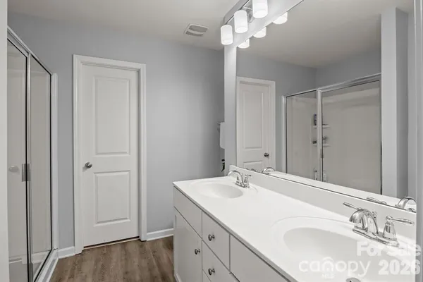 a bathroom with a sink vanity and a mirror