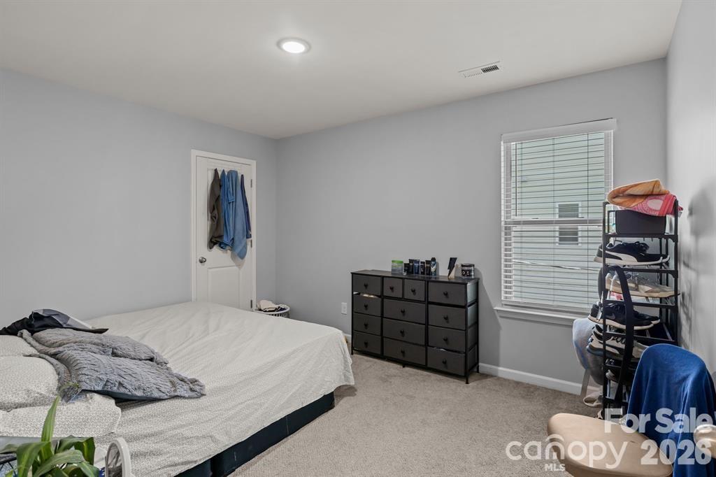 822 Lakehill Road Charlotte, NC 28214 - Photo 15 of 31 a bedroom with a bed and a dresser