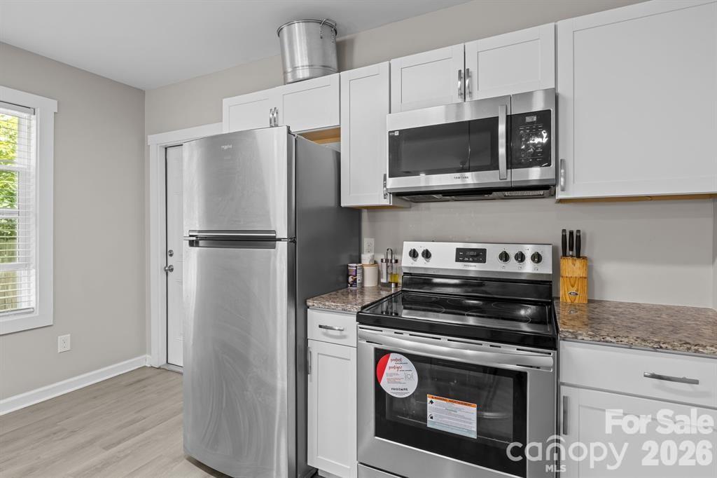 822 Lakehill Road Charlotte, NC 28214 - Photo 22 of 31 a kitchen with a stove and a microwave