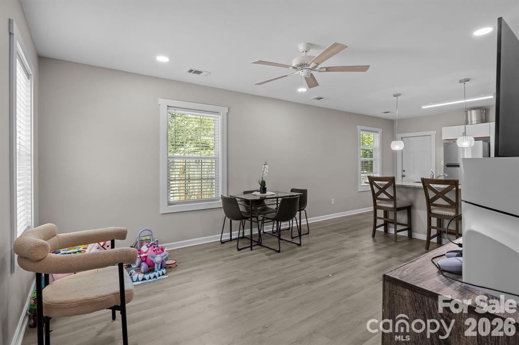 822 Lakehill Road Charlotte, NC 28214 - Photo 23 of 31 a dining room with furniture and wooden floor