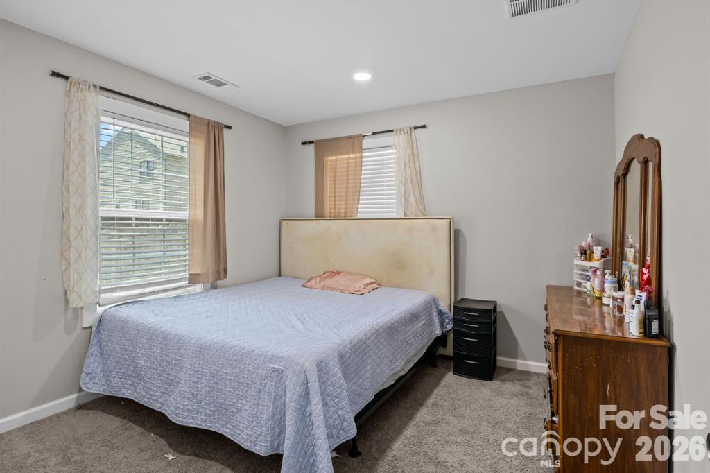 822 Lakehill Road Charlotte, NC 28214 - Photo 24 of 31 a bedroom with a bed and wooden floor