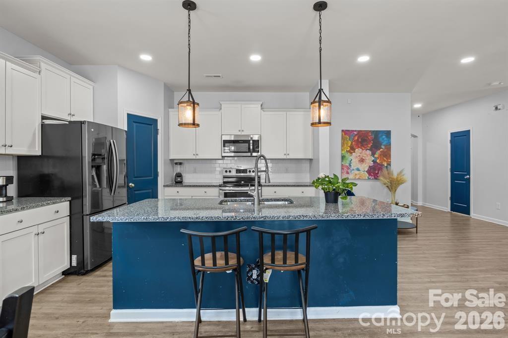 822 Lakehill Road Charlotte, NC 28214 - Photo 7 of 31 a kitchen with kitchen island a counter top space appliances and cabinets