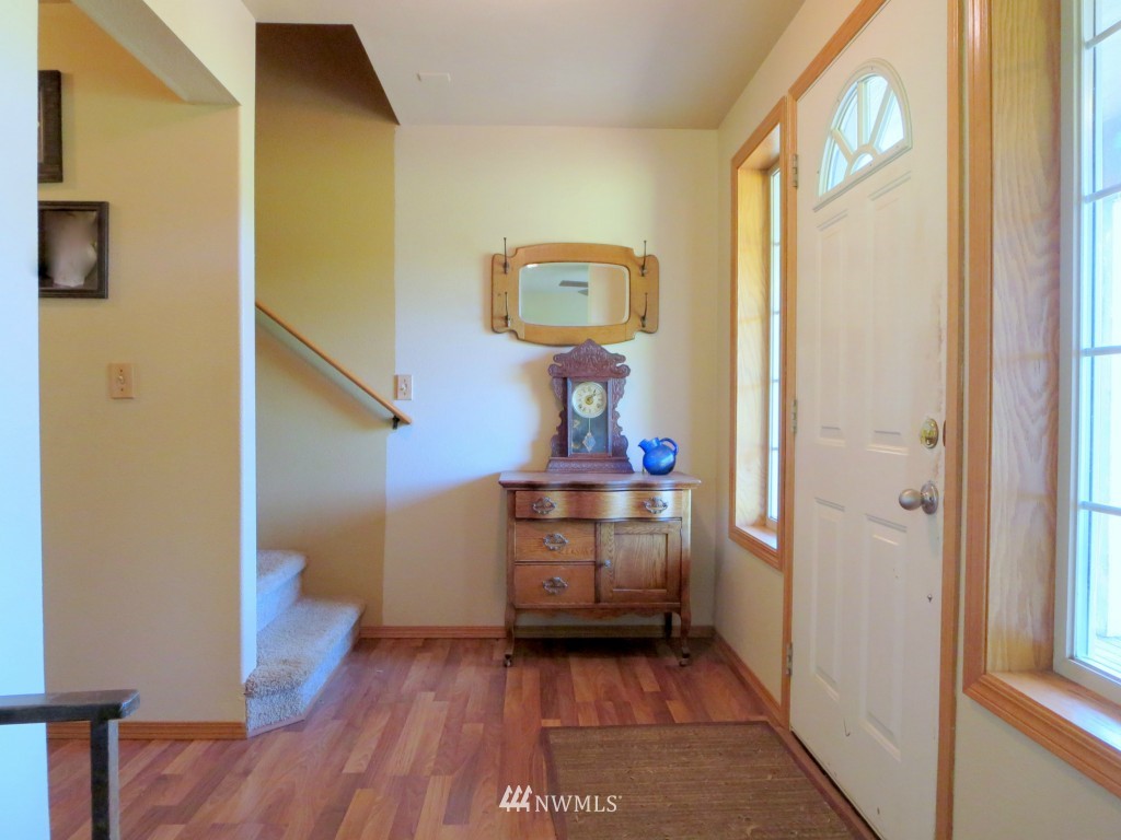 184 Piper Lane Chehalis, WA 98532 - Photo 6 of 25 a view of a hallway with entryway wooden floor and cabinet
