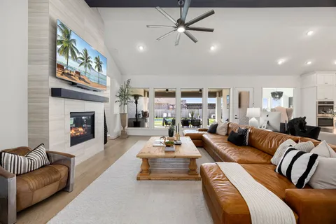 a living room with furniture fireplace and a chandelier
