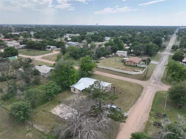 an aerial view of a house with a yard