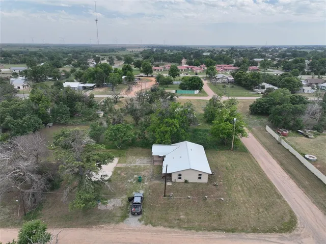 an aerial view of a house with yard