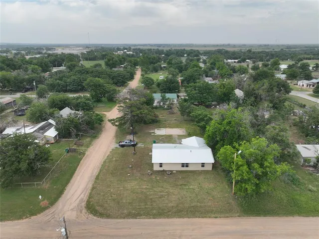 an aerial view of residential houses with outdoor space and river