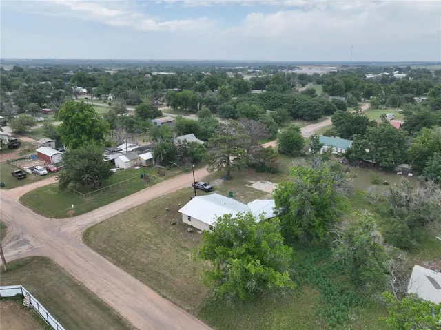 an aerial view of a house with a yard