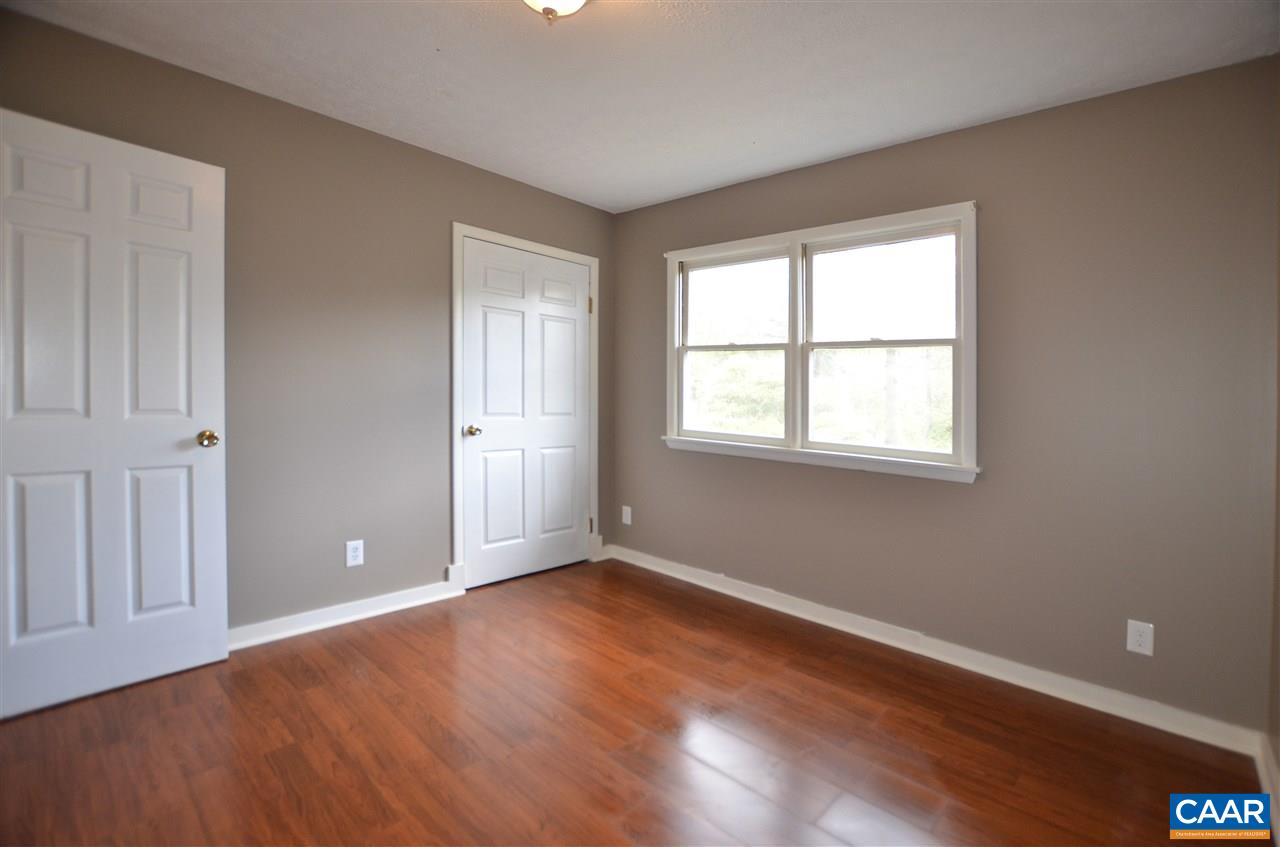 136 Bybees Church Road Palmyra, VA 22963 - Photo 22 of 43 a view of an empty room with wooden floor and a window