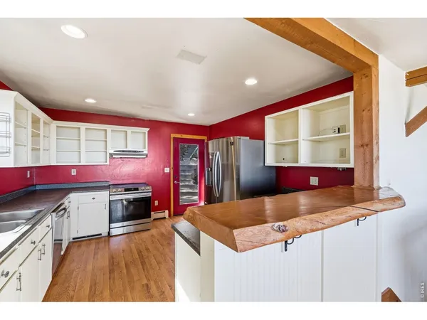 a kitchen with stainless steel appliances kitchen island granite countertop a sink and cabinets