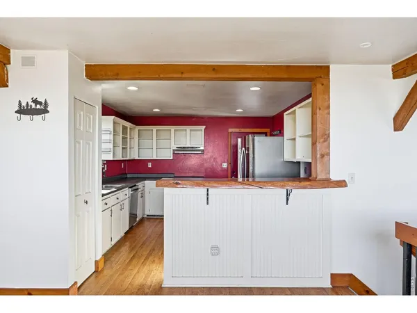 a kitchen with stainless steel appliances a refrigerator and a stove