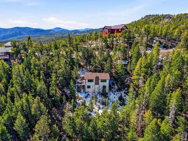 an aerial view of a house with a yard and balcony