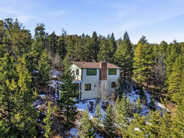an aerial view of a house with a yard and balcony