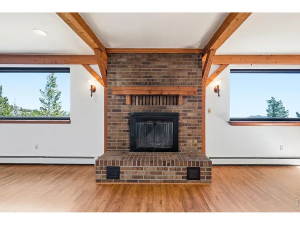 a view interior of a house wooden floor and fire place