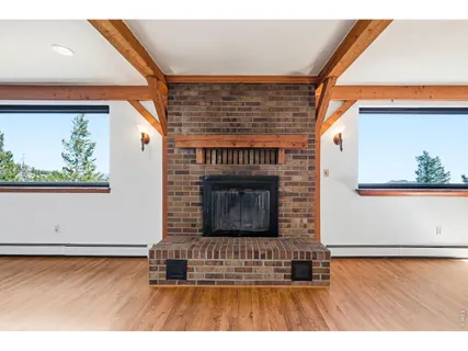 a view interior of a house wooden floor and fire place