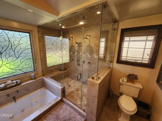 a bathroom with a tub mirror and sink