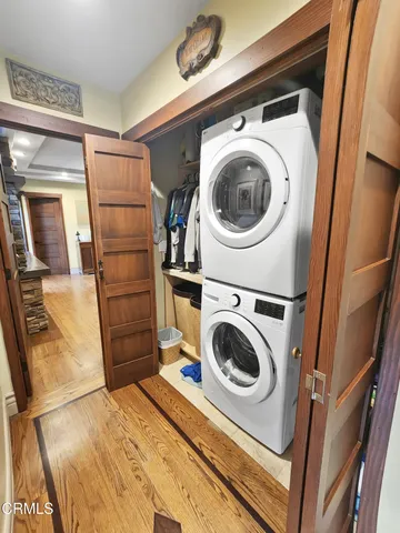 a view of a patio with table and chairs potted plants and a large tree