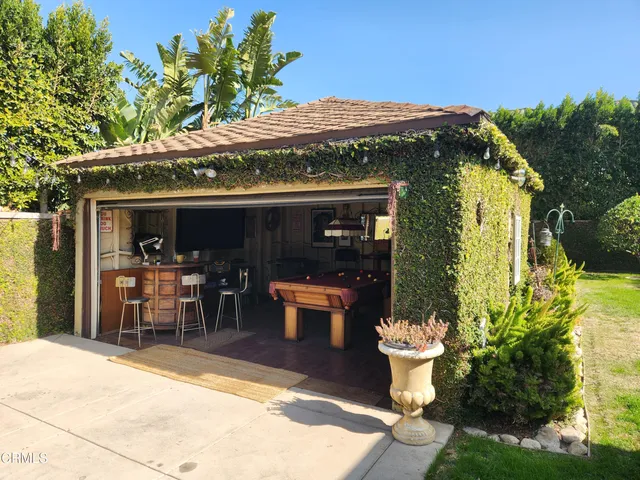 a view of a patio with table and chairs and potted plants