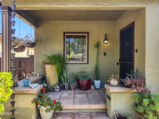 a living room with furniture a wooden floor and a chandelier