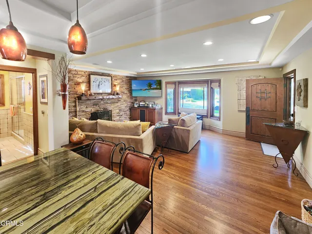 a kitchen with kitchen island granite countertop a stove a sink and a refrigerator