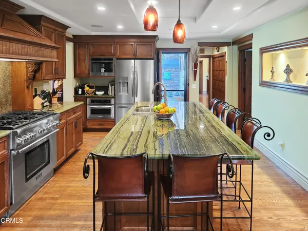 a kitchen with a dining table chairs and a chandelier