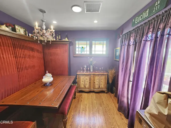 a spacious bedroom with a bed and wooden floor