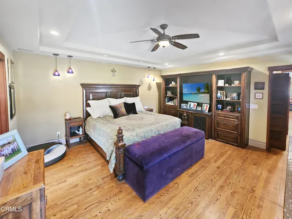 a bedroom with a bed and a flat screen tv with the dresser