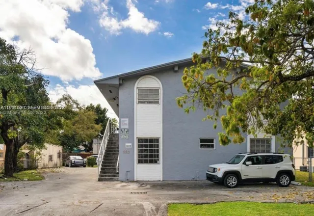 a view of a car parked in front of a house