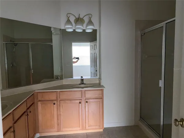 a bathroom with a sink a vanity and a mirror