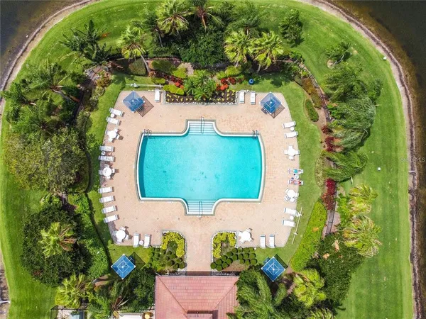 an aerial view of a house with a yard and green space