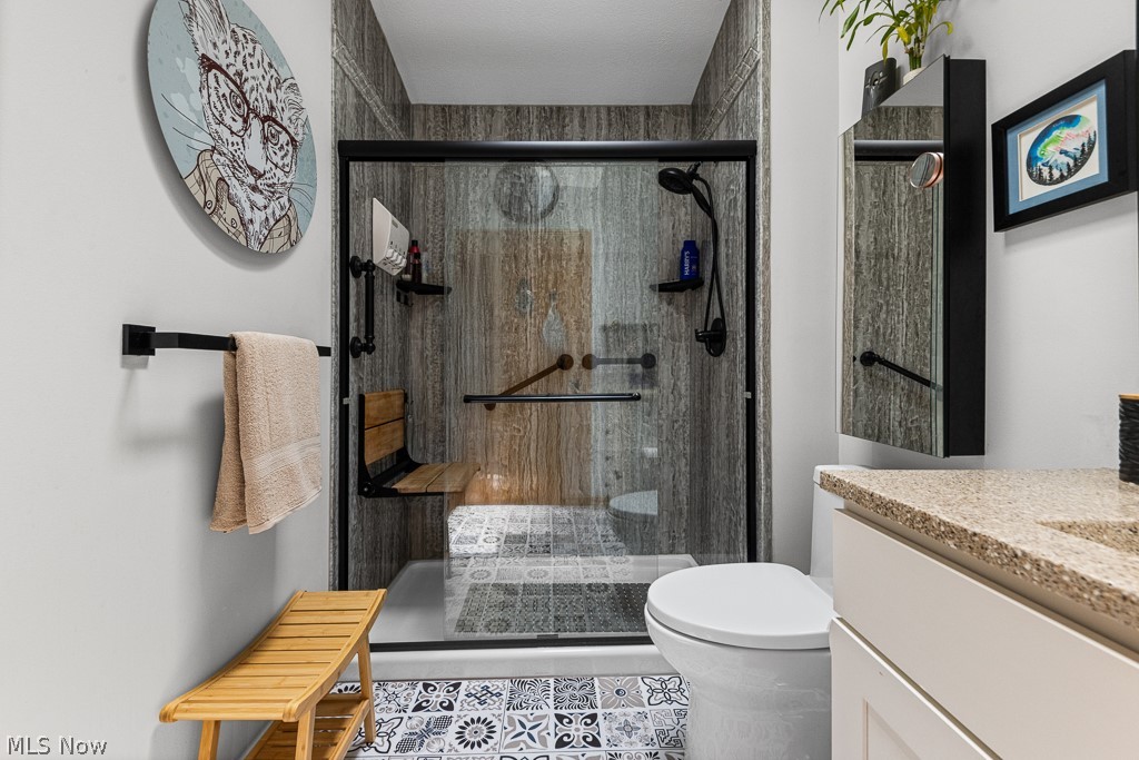 808 Ryan Road, Unit 14 Medina, OH 44256 - Photo 27 of 40 Modern bathroom featuring a walk-in shower with a glass enclosure, wood-look wall panels, and a built-in folding seat