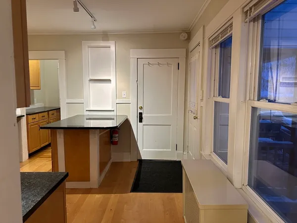 a walk in closet with view of front door