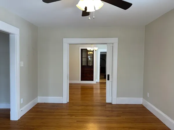 a view of a hallway with wooden floor