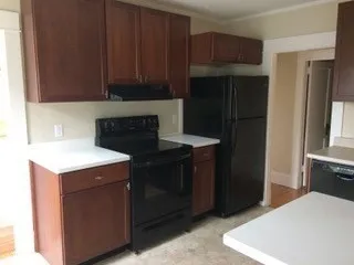 a kitchen with a refrigerator and cabinets