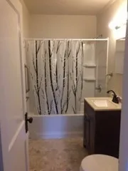 a bathroom with a sink and mirror with toilet