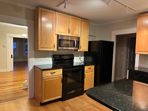 a kitchen with a refrigerator stove and microwave