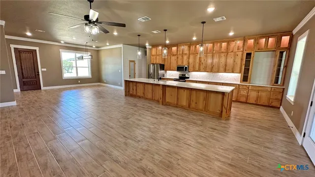 a hallway with washer and dryer with wooden floor