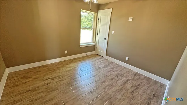 a bathroom with a sink a toilet a mirror and shower