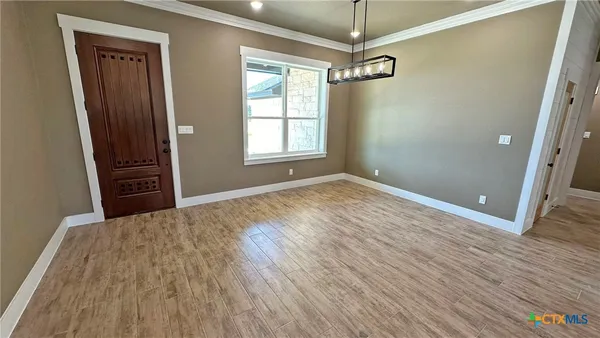 a view of a room with window and wooden floor