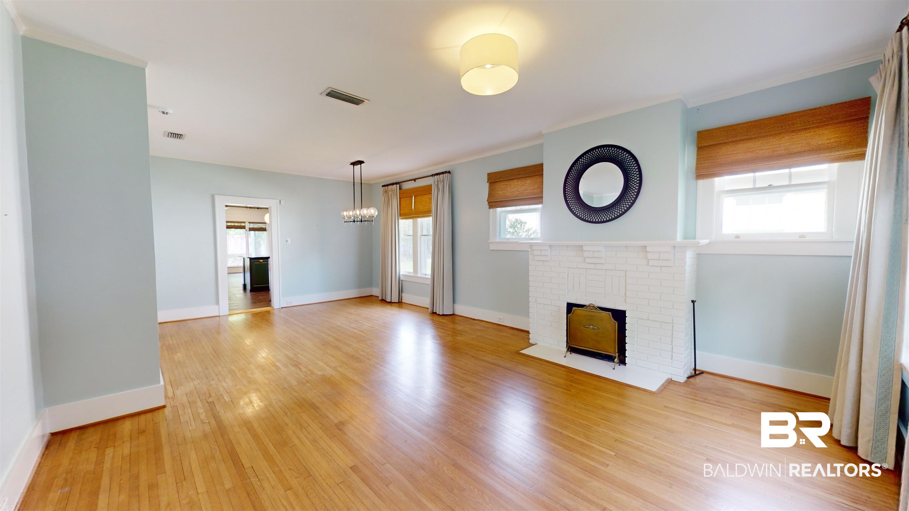 4307 Stein Street Mobile, AL 36608 - Photo 3 of 28 Unfurnished living room with a wealth of natural light, a brick fireplace, and light wood-type flooring