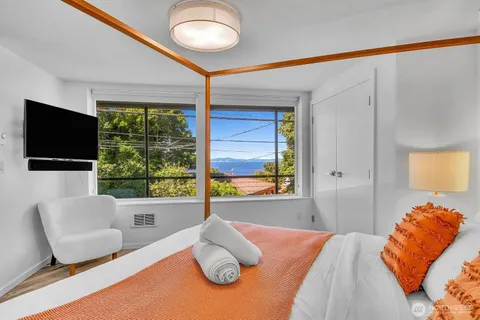 a bedroom with a bed and a large window